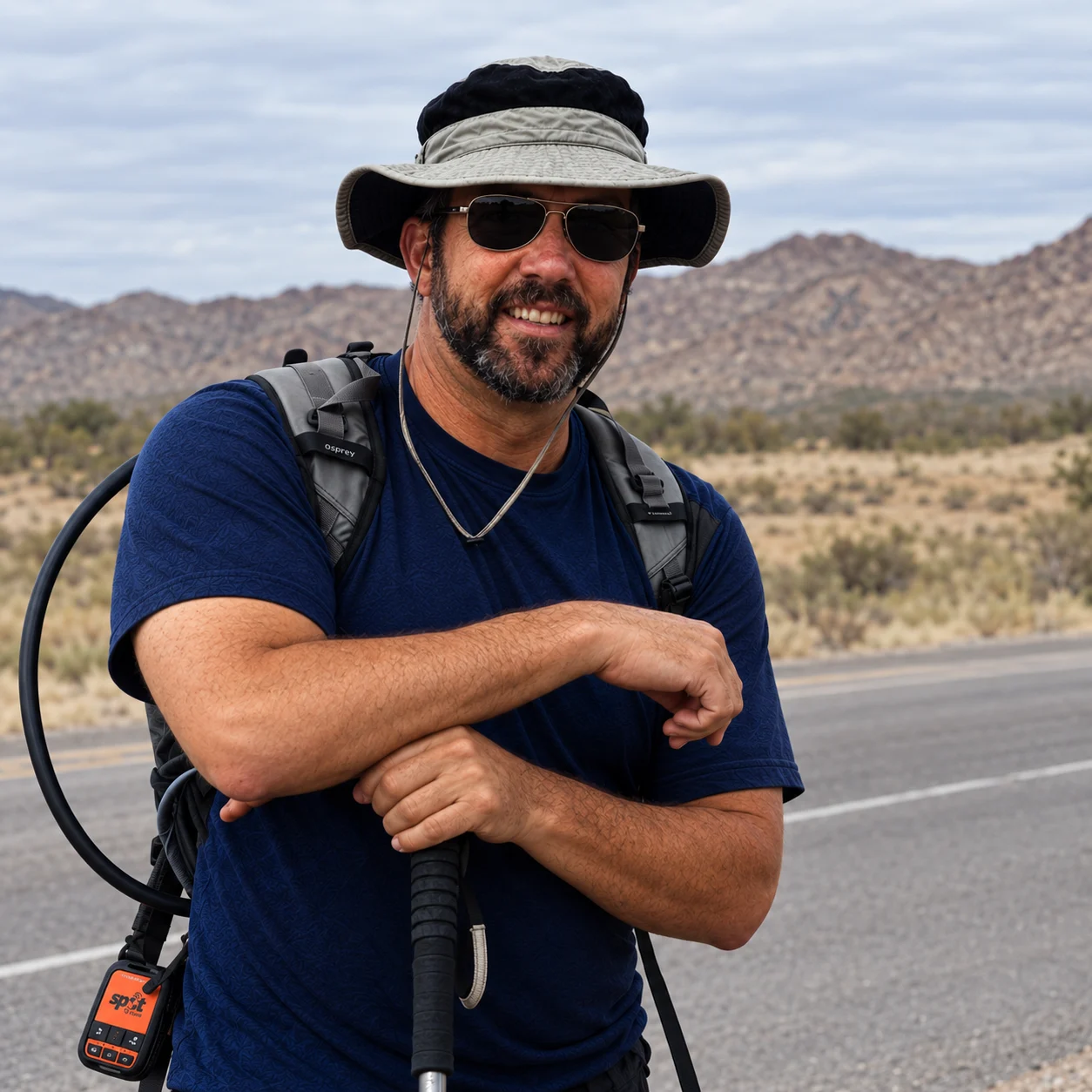 Steve Schwab with his backpack and walking poles beside a desert road